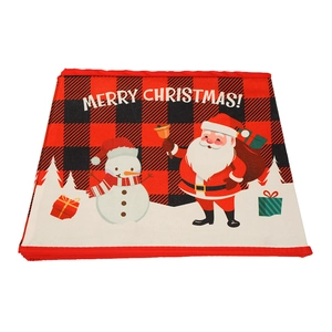 Detail of buffalo plaid Christmas tree skirt with Santa and snowman scene and holiday greeting