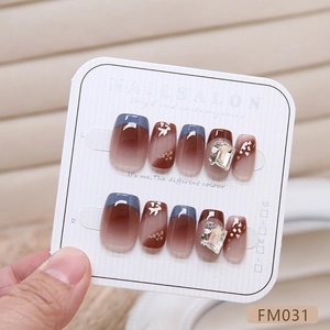 French luxury press-on nails with caramel gradient and blue tips featuring square rhinestones