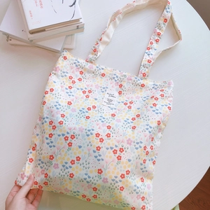 Floral cotton canvas tote bag with colorful small flower print and shoulder straps