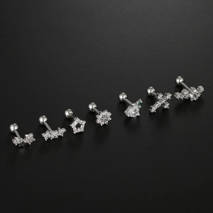 Detailed array of silver surgical steel cartilage studs featuring zirconia star and floral shapes