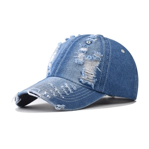 Washed blue denim baseball cap with distressed rip details and a classic curved brim