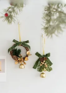 Detail of Christmas wreath and bell charms with velvet ribbon and pine cones