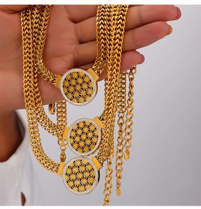 Vue détaillée de la chaîne épi dorée avec pendentif fleur de vie ajouré et zircon