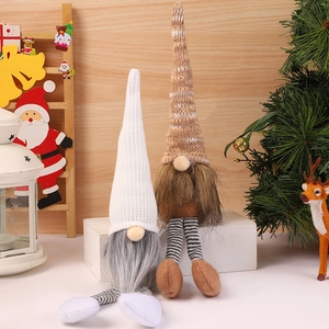Christmas gnomes with knitted hats and striped legs as festive holiday decorations