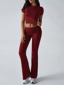 Detail of dark red two-piece lounge set with short sleeve crop top and flared pants