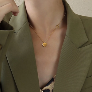 Close-up of 18K gold plated stainless steel necklace featuring double heart pendants