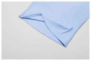 Detail of high-stretch fabric with flatlock stitching on light blue yoga tank top