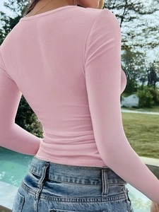 Close-up back view of a slim-fit pink long-sleeve Y2K top with professional outdoor tailoring