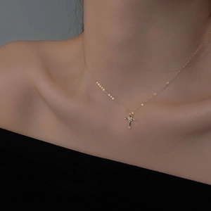 Elegant gold cross necklace for women featuring sparkling cubic zirconia on a dainty chain