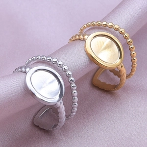 Detail of adjustable double-layer twisted rings with oval flat base in gold and silver