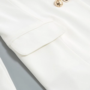 Close-up of golden embossed buttons and pocket on a professional white suit jacket
