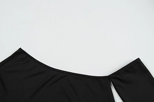 Detail of a black off-shoulder neckline with professional stitching on elastic knit fabric