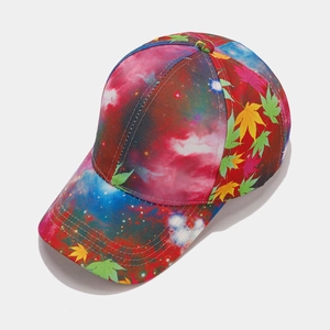 Close-up of baseball cap with galaxy nebula print and colorful maple leaf patterns