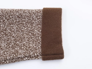 Detail shot of fuzzy knit brown texture and snowflake pattern on cuff for women