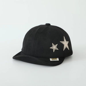 Detail shot of black kids suede cap with star embroidery and brand tag on brim