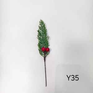 Close-up of artificial pine needles with red berries for Christmas floral decorations