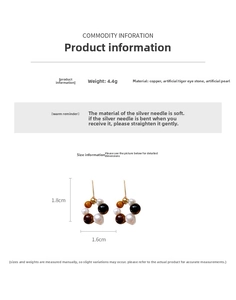 Size specifications and macro detail of pearl and tiger eye beaded hoop earrings