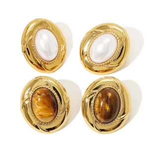 Vintage oval pearl and brown stone clip earrings set with textured gold metal frames