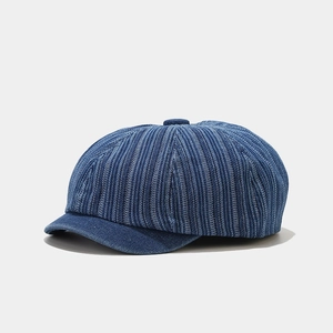 Detail showing the textured stripe dark blue denim fabric of this newsboy cap