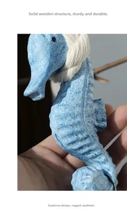 Detail of hand-carved solid wood seahorse wall decor with rustic light blue finish