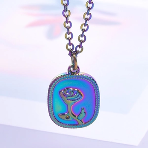 Close-up of rainbow stainless steel square pendant featuring a vintage embossed rose design