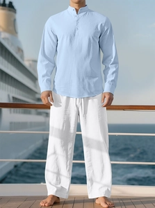 Close-up of light blue linen shirt and white drawstring pants on a cruise ship deck