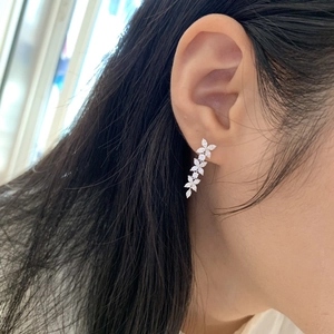 Silver marquise zircon floral drop earrings elegantly worn by a model in a close-up view