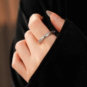 Close-up of twisted silver ring with micro-paved zircons worn on a finger