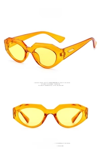 Detail of orange cat eye sunglasses with yellow lenses and gold temple hardware