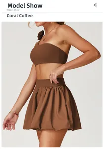 Detail view of quick-dry tennis skirt in coral brown with high waist pleated design
