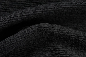 Détail macro du tissu seersucker noir de haute qualité avec texture froissée élégante et mate