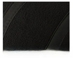 Close-up of the warm black wool fabric and detailed stitching on a men's flat cap