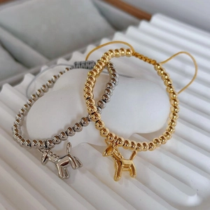 Adjustable woven bracelet with 18k gold plated beads and a cute balloon dog pendant