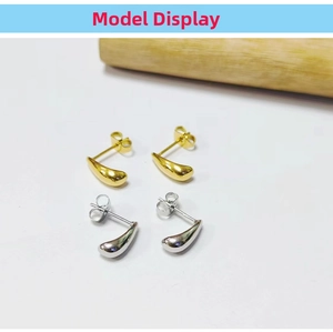 Macro detail of minimalist water drop earrings in 18K gold and silver plating