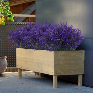 Vibrant purple artificial lavender stems in a rustic wooden planter box for outdoor decor