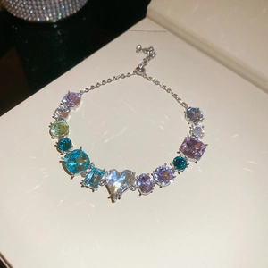 Detail view of colorful heart and square zirconia stones on an adjustable silver chain