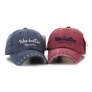 Detail of distressed baseball caps in navy and burgundy with Take boston embroidery