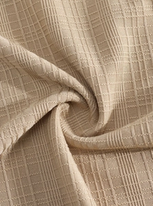 Macro texture detail of beige linen-style knit fabric with vertical ribbing and soft layers