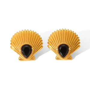 Detail of shell-shaped 18K gold earrings with teardrop black zircon center on white background