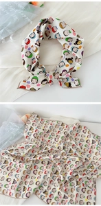 Detail of cartoon girl print on lightweight linen silk scarf with soft hemmed edges