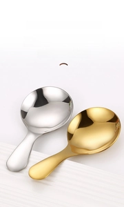 Macro detail showing round spoon surface with polished gold and silver metal finishes