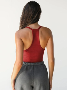 Close-up of the racerback detail on this red ribbed knit tank top for a slim fit look