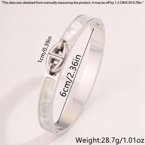 Detail view of silver stainless steel bangle with white mother of pearl inlay and H-link clasp