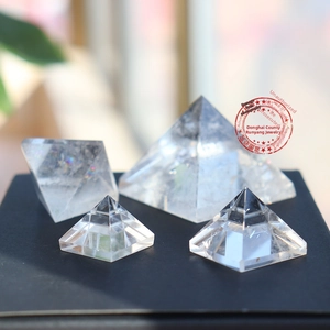 Macro detail of four clear natural white crystal pyramids showing internal ice crack textures