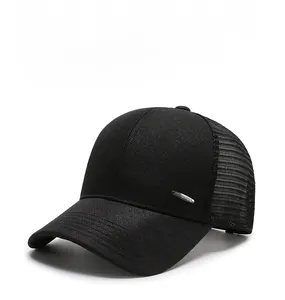 Detail of black trucker hat showing breathable mesh panels and silver metal accent