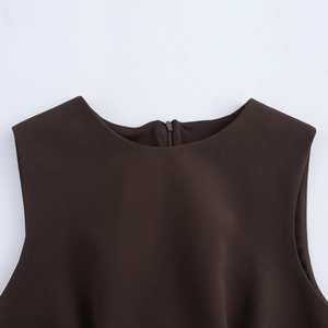 Detail of round neckline and back zipper closure on dark brown sleeveless dress