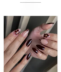 Detailed view of almond press-on nails featuring floral art and brown leopard patterns