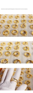 Detail of gold double-layer wave textured rings with a polished finish and minimalist style