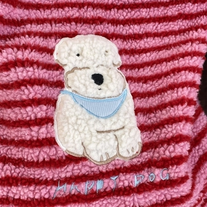 Macro detail of plush striped fabric featuring a cute 3D dog patch and Happy Dog embroidery