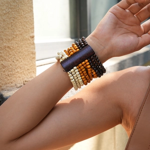 Detail of bohemian multilayered wooden beads bracelet with retro geometric wood pieces